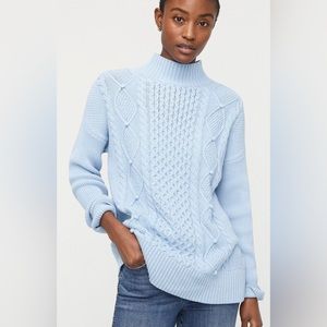 Swingy cableknit mockneck sweater